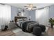 Well-lit main bedroom with contemporary decor, ceiling fan, wood-look flooring, and sheer curtains at 2496 Shiloh Dr, Decatur, GA 30034