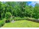 Fenced backyard with lush lawn and mini-house, perfect for outdoor activities and serene relaxation at 4361 Kimball Rd, Atlanta, GA 30331
