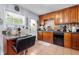 Functional kitchen with tile backsplash, wooden cabinets and a breakfast bar at 4361 Kimball Rd, Atlanta, GA 30331