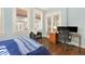 Bright bedroom with light blue walls, hardwood floors, and a functional workspace with a desk at 746 N Highland Ne Ave # 7, Atlanta, GA 30306