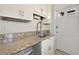 Granite countertops, stainless steel appliances, and white cabinetry create a modern kitchen space at 746 N Highland Ne Ave # 7, Atlanta, GA 30306