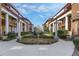 Inviting courtyard featuring manicured gardens, charming architecture, and well-maintained sidewalks under a partly cloudy sky at 746 N Highland Ne Ave # 7, Atlanta, GA 30306
