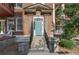 Charming brick home featuring a stylish blue door with black railing and stone stairs at 746 N Highland Ne Ave # 7, Atlanta, GA 30306