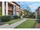 Charming exterior view showcasing lush landscaping, sidewalks, and stately columns under a partly cloudy sky at 746 N Highland Ne Ave # 7, Atlanta, GA 30306