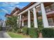 Elegant exterior view highlighting the classic architecture, balcony, and lush greenery under a partly cloudy sky at 746 N Highland Ne Ave # 7, Atlanta, GA 30306