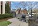 Outdoor grill area with stone surround, convenient seating, and a glimpse of neighborhood charm at 746 N Highland Ne Ave # 7, Atlanta, GA 30306