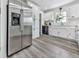 Modern kitchen with stainless steel refrigerator, white cabinetry, and sleek countertops at 104 Cochran Ridge Rd, Dallas, GA 30157