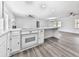 Spacious kitchen with a center island, white cabinets, and view into an open living area at 104 Cochran Ridge Rd, Dallas, GA 30157