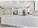 Kitchen island with white countertop, stainless steel appliances, and view of the combined living space at 104 Cochran Ridge Rd, Dallas, GA 30157