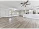 Open-concept living room showcasing a kitchen, dining area, and gray wood-look flooring at 104 Cochran Ridge Rd, Dallas, GA 30157