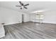 Bright living room with modern ceiling fan, chandelier, and gray wood-look flooring at 104 Cochran Ridge Rd, Dallas, GA 30157