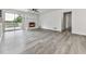 Bright living room with a fireplace, sliding doors, and a hallway leading to the bedrooms at 104 Cochran Ridge Rd, Dallas, GA 30157