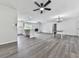 Large open living space with modern kitchen, dining area, fireplace, and gray wood-look flooring at 104 Cochran Ridge Rd, Dallas, GA 30157