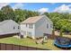 Well-maintained backyard featuring a patio, fire pit, play set, green grass, and privacy fence at 501 White Oak Path, Canton, GA 30115