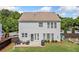 Back exterior view showcasing a large backyard and patio area with outdoor seating at 501 White Oak Path, Canton, GA 30115