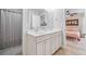 Bathroom featuring a double sink vanity, tiled floors, with a peek of the bedroom at 501 White Oak Path, Canton, GA 30115