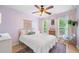 A bedroom with lavender walls, a white comforter and lots of natural light at 501 White Oak Path, Canton, GA 30115