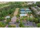 Aerial view featuring the community clubhouse, pools, tennis courts, and convenient parking at 501 White Oak Path, Canton, GA 30115