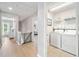 Hallway leading to a bedroom and laundry room with white washer and dryer at 501 White Oak Path, Canton, GA 30115
