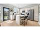 Bright kitchen with stainless steel appliances, white cabinets, island, and patio door at 501 White Oak Path, Canton, GA 30115