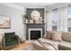 Cozy living room with a fireplace, hardwood floors, and a comfortable sectional sofa at 501 White Oak Path, Canton, GA 30115