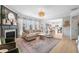 Spacious living room with fireplace, hardwood floors, and seamless access to the kitchen at 501 White Oak Path, Canton, GA 30115