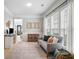Cozy living room featuring a comfortable gray sofa, a TV on a console, and a neutral rug at 501 White Oak Path, Canton, GA 30115