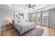 Primary bedroom with tray ceilings, ceiling fan, hardwood floors, and lots of natural light at 501 White Oak Path, Canton, GA 30115