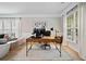 Sunlit home office space with large desk, multiple monitors, and comfortable seating area at 501 White Oak Path, Canton, GA 30115