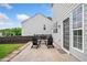 Side view of the home's patio with a dining set and fenced backyard at 501 White Oak Path, Canton, GA 30115