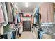 Walk-in closet with built-in shelving, hanging racks, and carpeted floors at 501 White Oak Path, Canton, GA 30115