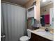 Bathroom with a shower/tub, a single sink vanity, neutral walls, and a mirrored medicine cabinet at 5976 Rosie Se Ln, Mableton, GA 30126