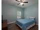 A simple bedroom with a comfortable bed, ceiling fan, and natural lighting at 5976 Rosie Se Ln, Mableton, GA 30126