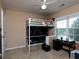 Bedroom with lofted bed, carpeted floor, ample lighting from a large window, and a study desk at 5976 Rosie Se Ln, Mableton, GA 30126