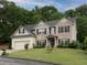 Charming two-story home with brick and siding, a well-manicured lawn, and an attached two-car garage at 5976 Rosie Se Ln, Mableton, GA 30126