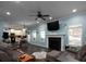 Open-concept living room with fireplace, hardwood floors, and seamless flow to the kitchen at 5976 Rosie Se Ln, Mableton, GA 30126