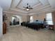 Spacious main bedroom with a tray ceiling, fan, and comfortable carpeting at 5976 Rosie Se Ln, Mableton, GA 30126