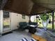 Covered outdoor patio featuring comfortable seating, string lights, and a hammock swing, perfect for relaxation at 5976 Rosie Se Ln, Mableton, GA 30126