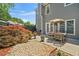 Serene backyard featuring gravel beds, patio, dining set, and manicured plants, perfect for outdoor enjoyment at 1201 Bridle Path, Marietta, GA 30068