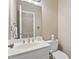 Clean half bathroom featuring a white vanity, mirror, and toilet, ideal for guests at 1201 Bridle Path, Marietta, GA 30068
