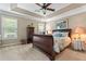 Bedroom with tray ceilings, ceiling fan, carpet, and large windows with blinds at 1201 Bridle Path, Marietta, GA 30068