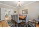 Elegantly appointed dining room with views into the living area, featuring neutral tones at 1201 Bridle Path, Marietta, GA 30068