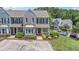 Charming townhome with a painted brick and clapboard facade, a welcoming porch, and a well-maintained landscaped yard at 1201 Bridle Path, Marietta, GA 30068