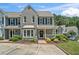 Charming two-story townhome with gray brick and siding, complemented by a well-maintained front yard at 1201 Bridle Path, Marietta, GA 30068