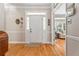 Welcoming foyer with hardwood floors, a decorative front door, and a glimpse into the living area at 1201 Bridle Path, Marietta, GA 30068