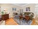 Cozy living room with warm tones, a plush couch, and hardwood floors, ideal for relaxation at 1201 Bridle Path, Marietta, GA 30068