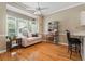 Bright living space with hardwood floors, a cozy couch, and natural light from a bay window at 1201 Bridle Path, Marietta, GA 30068