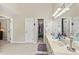 Main bathroom with lots of cabinets, dual vanity, and doorways to closet at 1201 Bridle Path, Marietta, GA 30068