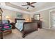 Bedroom with a bed dressed in floral bedding, side tables and a sitting area at 1201 Bridle Path, Marietta, GA 30068