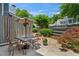 Charming patio setting with table, chairs, umbrella, and lush landscaping creates a cozy outdoor retreat at 1201 Bridle Path, Marietta, GA 30068